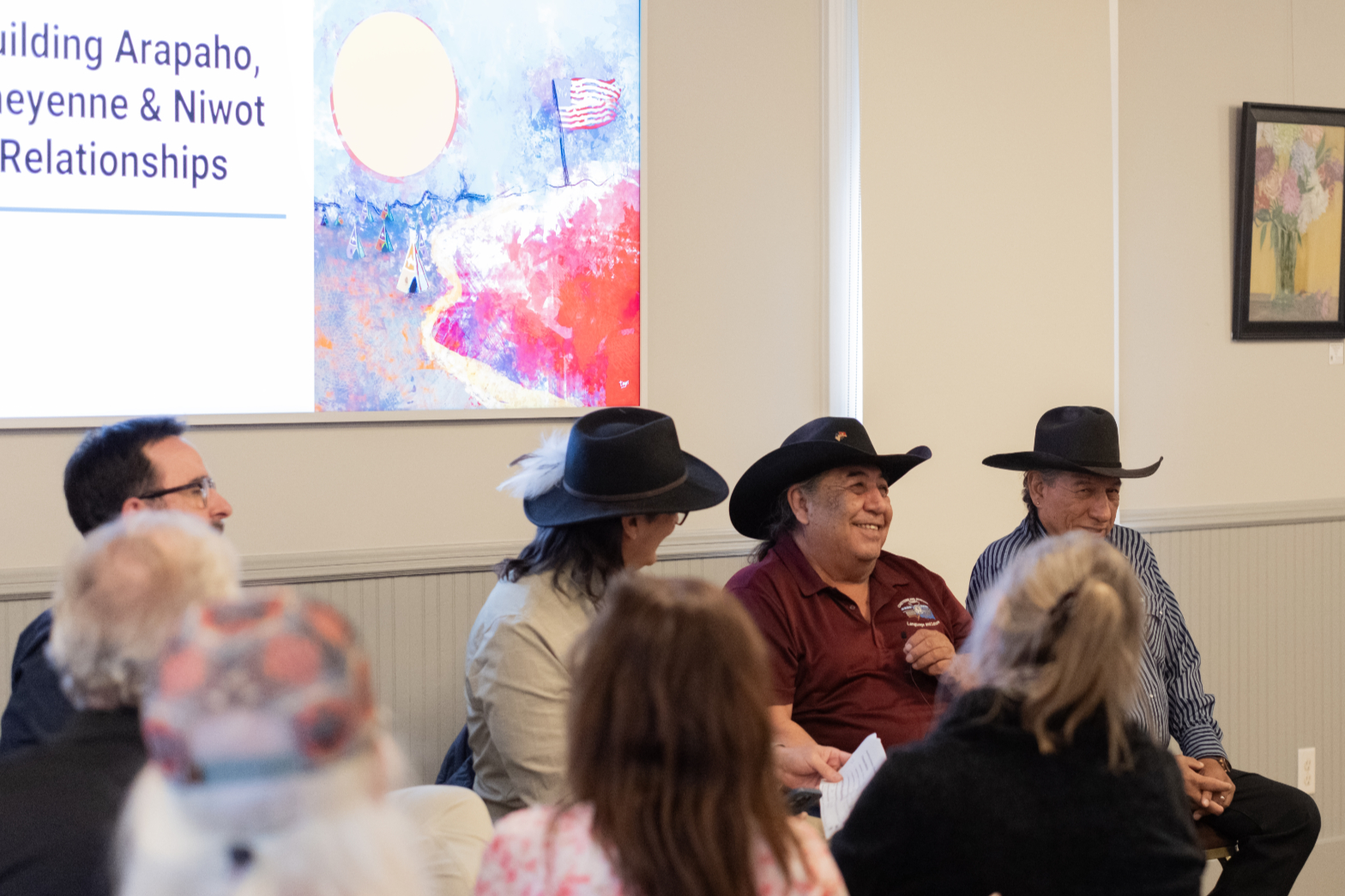 Chester Whiteman, Southern Cheyenne, seated with fellow Tribal Representatives during the Niwot community program.