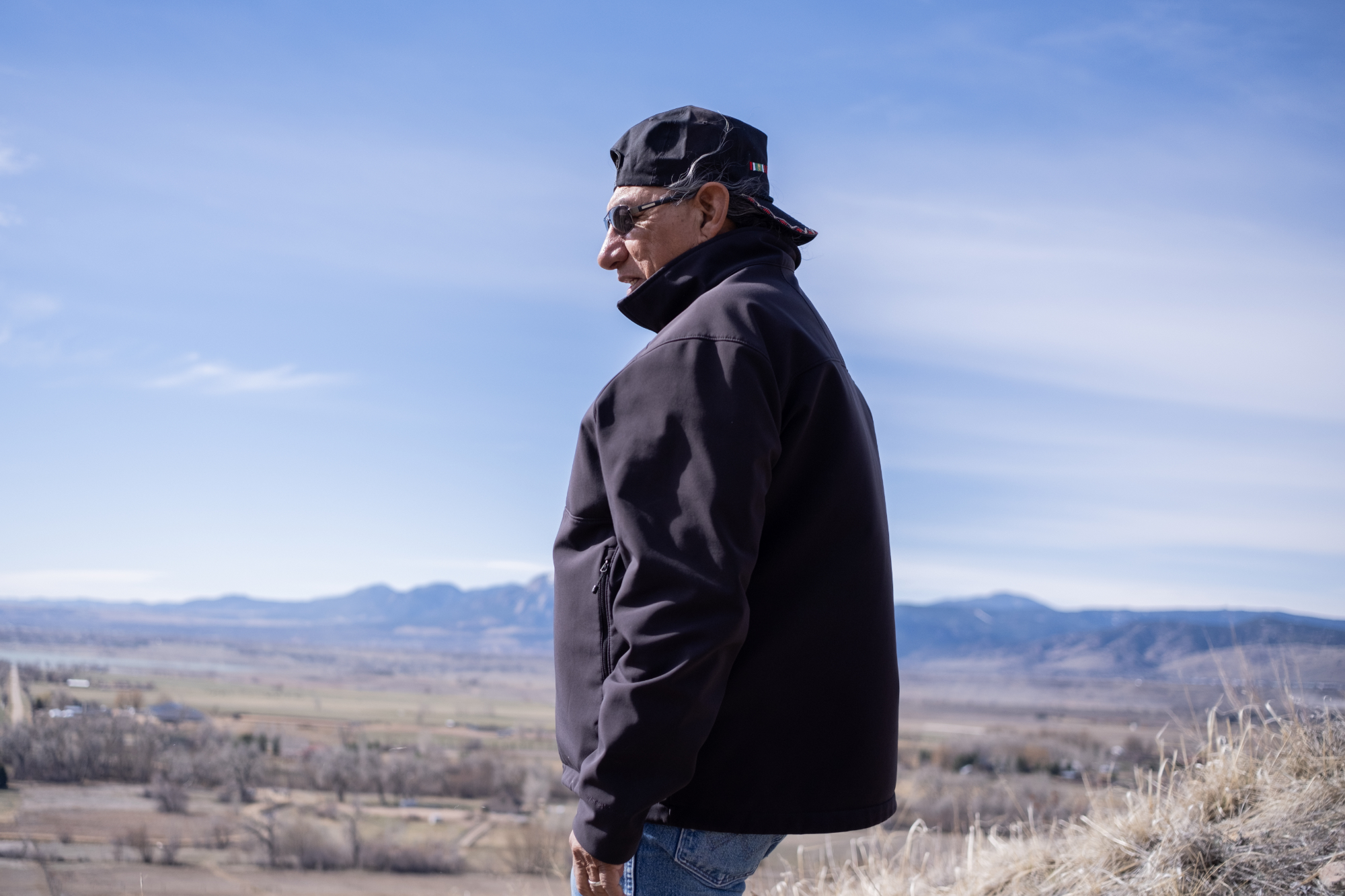 Southern Arapaho Elder Fred Mosqueda gazing west toward the foothills from Haystack Mountain.
